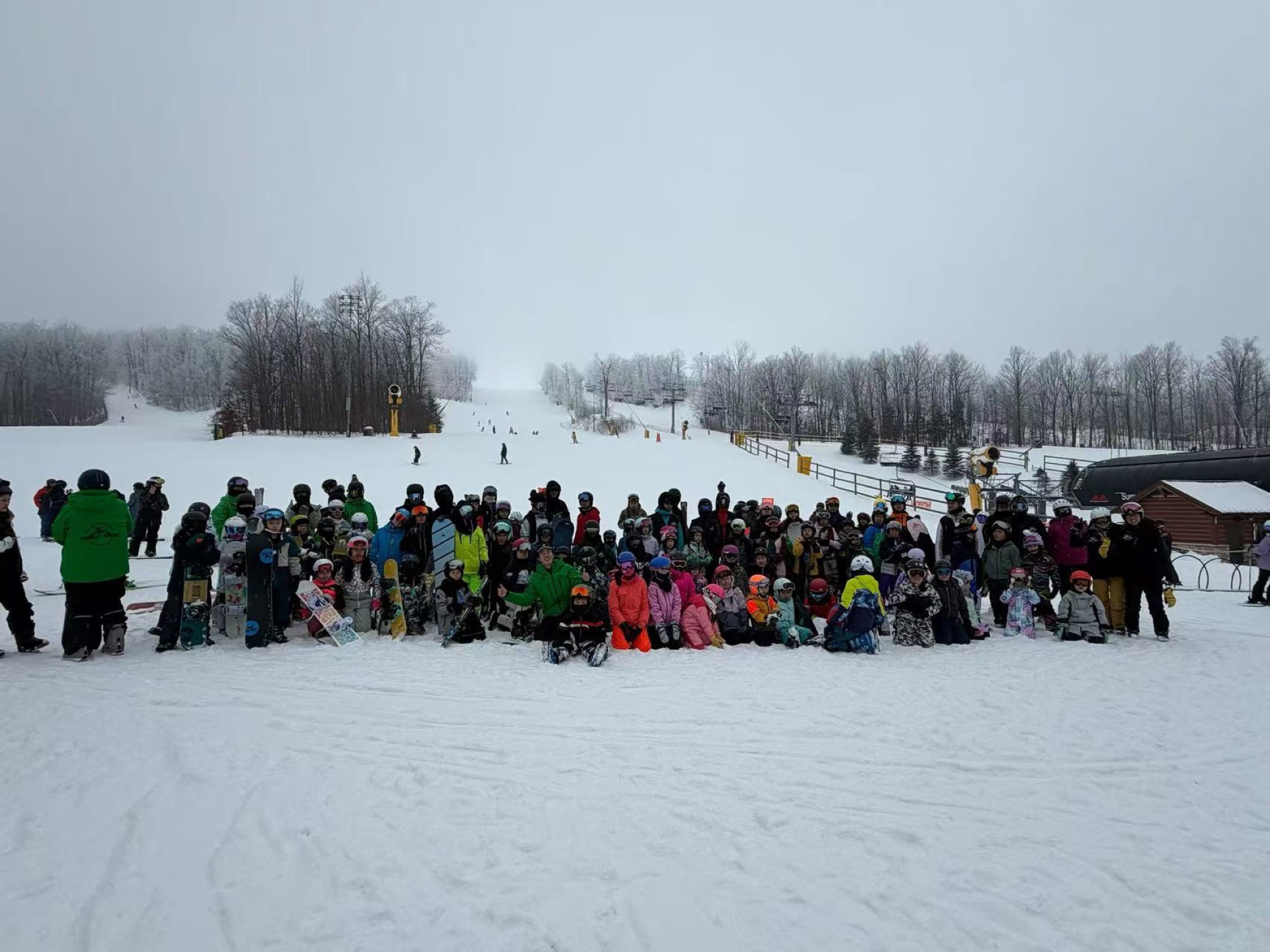 The full BoardXtreme camp — students and coaches gathered at the base of the hill