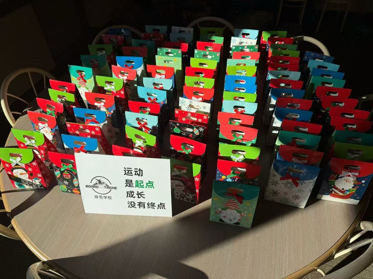 Holiday gift bags prepared for every student, with the club motto on a sign