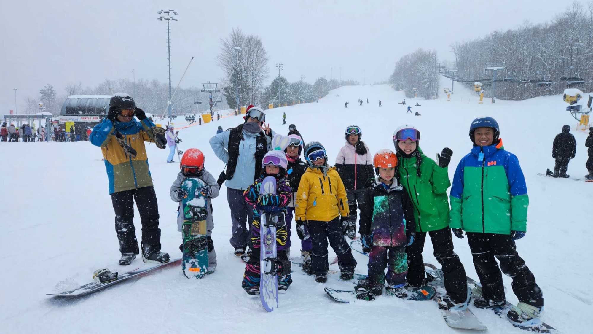 A BoardXtreme group lesson lined up on a snowy beginner slope